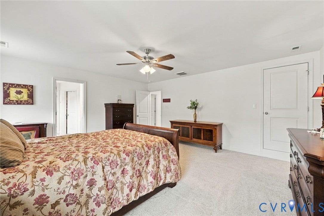 Ceiling fan with light kit, wall-to-wall carpeting, and white paneled interior doors