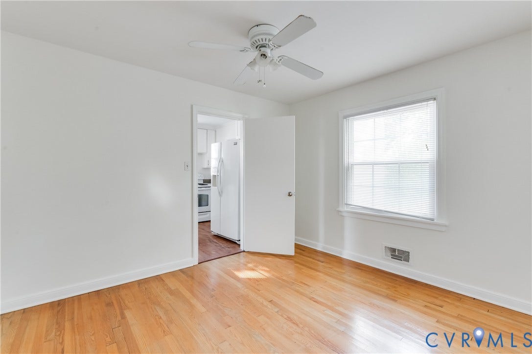 1701 Kingswood Street, Richmond, VA 23224 Wood-finish flooring, white walls, ceiling fan with integrated lighting, and single-hung window