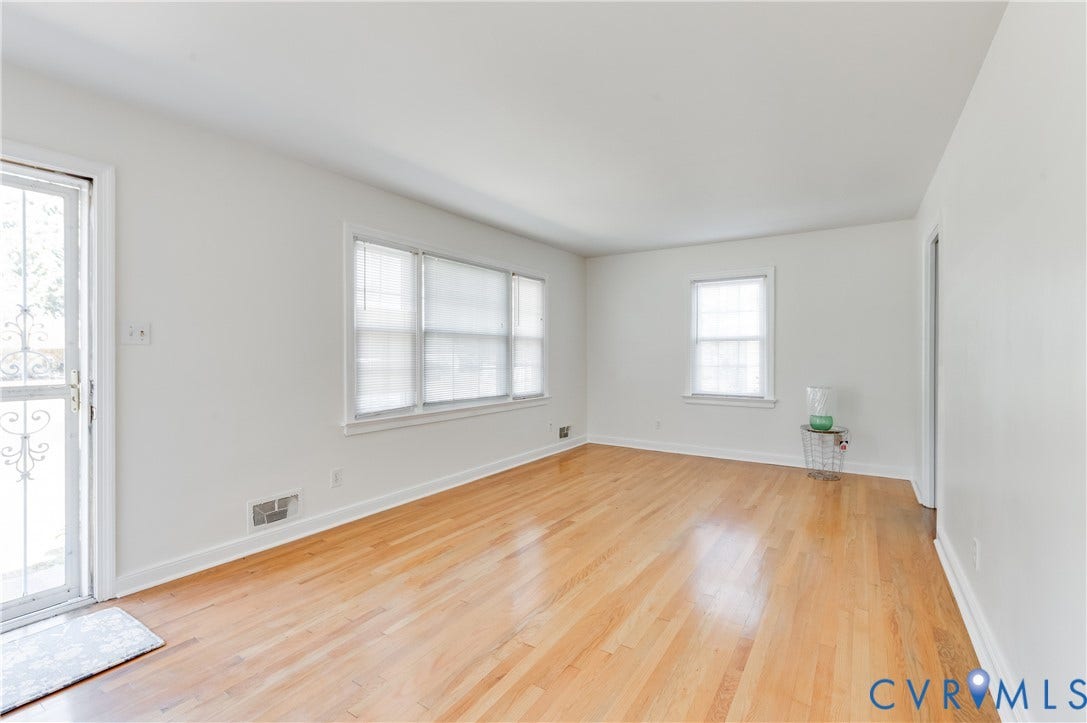 1701 Kingswood Street, Richmond, VA 23224 Interior space featuring wood-finish flooring, white walls, large multi-pane windows, and a glass-paneled exterior door