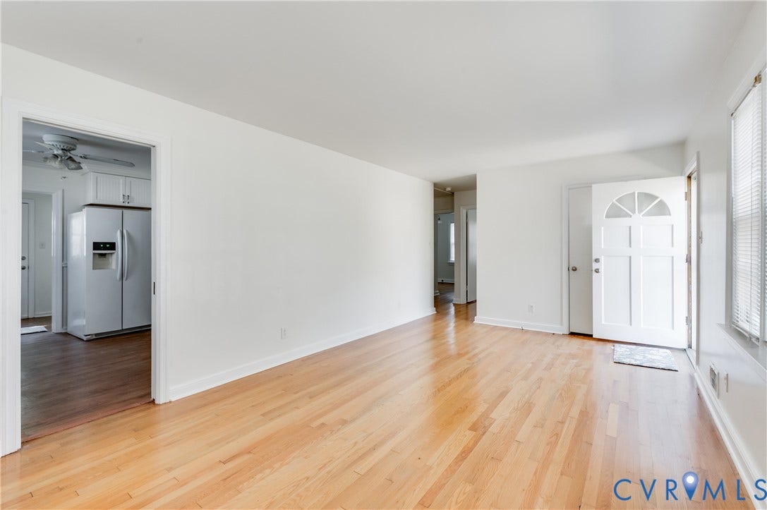 1701 Kingswood Street, Richmond, VA 23224 Neutral interior featuring wood-finish flooring, white walls, and a multi-paneled front door with an arched transom window