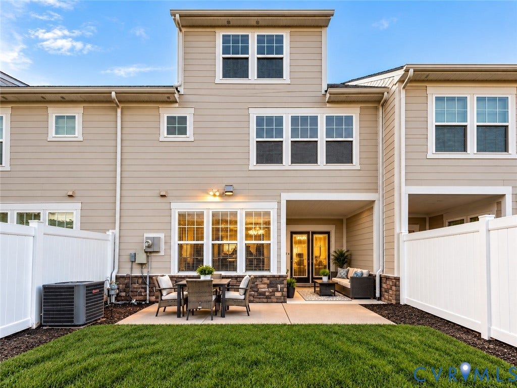 10507 Benoni Trail, Glen Allen, VA 23059 Expansive rear exterior featuring a covered patio, additional uncovered patio, and a manicured lawn