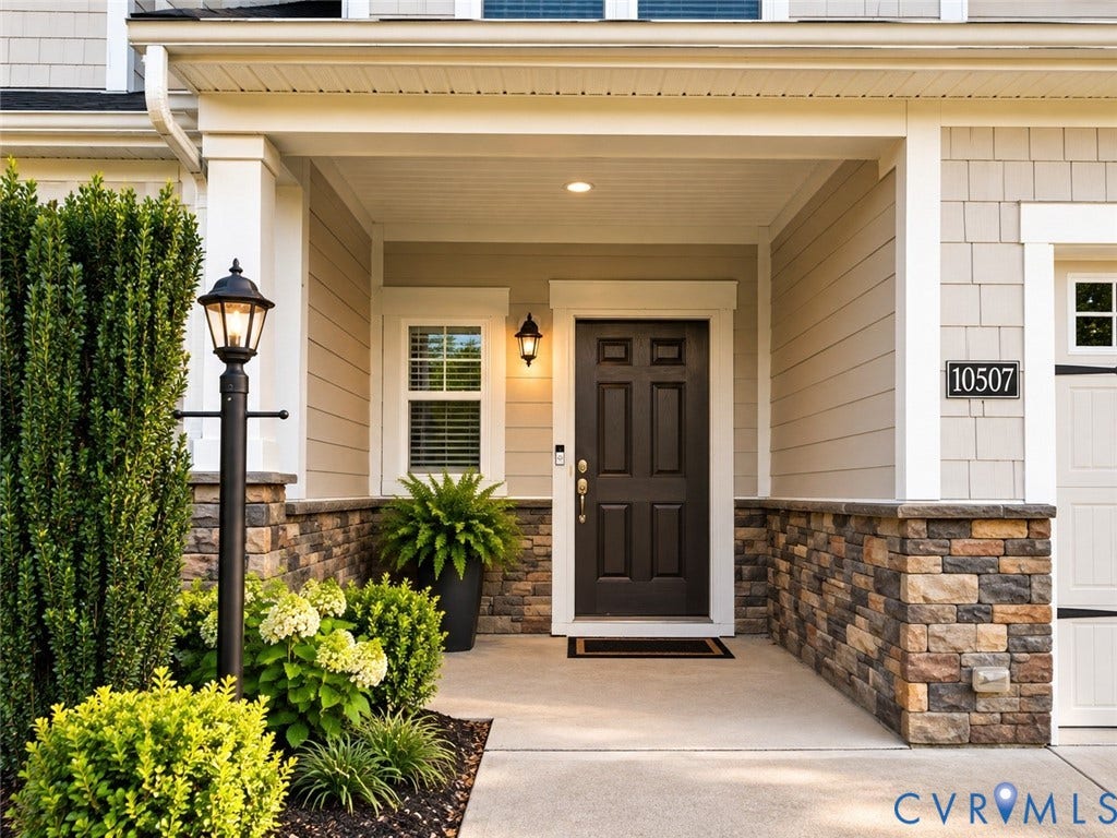 10507 Benoni Trail, Glen Allen, VA 23059 Welcoming covered entryway featuring a paneled door, stone veneer accents, and an exterior light fixture