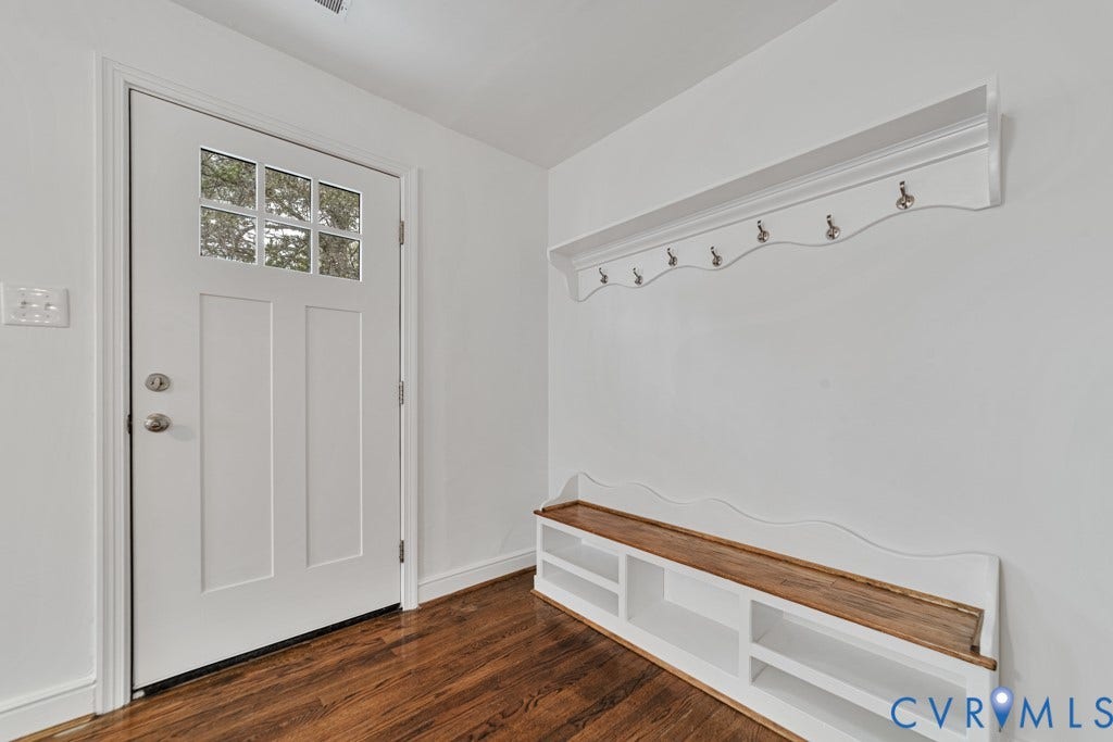 4130 Sprenkle Lane, Wistar Heights, Henrico, VA 23228 Hardwood flooring, white paneled door with glass inserts, built-in shelving, white wall-mounted coat rack, and white interior walls