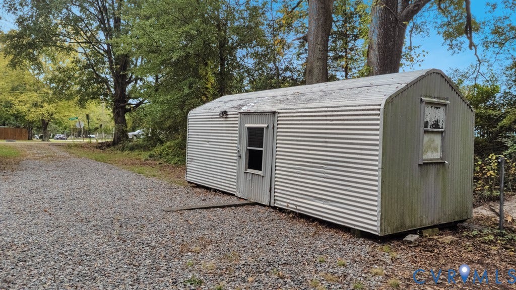 4130 Sprenkle Lane, Wistar Heights, Henrico, VA 23228 Corrugated metal shed with a pitched roof, a single door, and two windows
