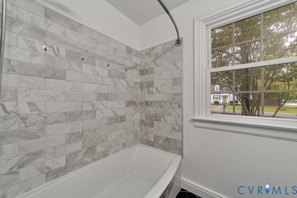 4130 Sprenkle Lane, Wistar Heights, Henrico, VA 23228 Bathtub with subway tile surround, white window trim, and a clear glass window