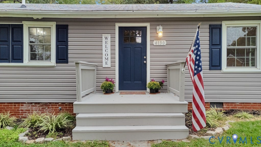 4130 Sprenkle Lane, Wistar Heights, Henrico, VA 23228 Gray horizontal siding exterior with a dark blue entry door, white trim windows, and dark blue shutters