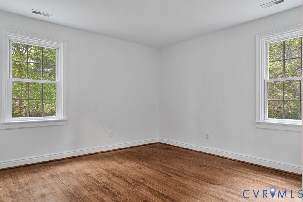 4130 Sprenkle Lane, Wistar Heights, Henrico, VA 23228 Hardwood flooring, white painted walls, white trim, and two double-hung windows
