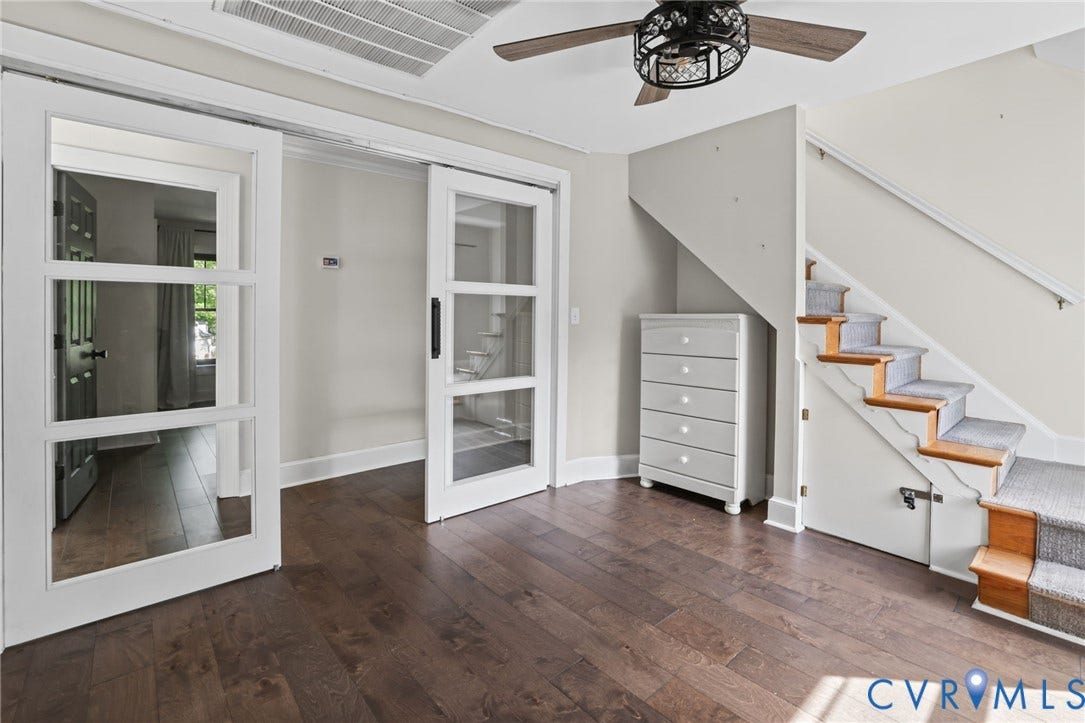 Office or additional area with doors and view or staircase to third floor bonus room and storage