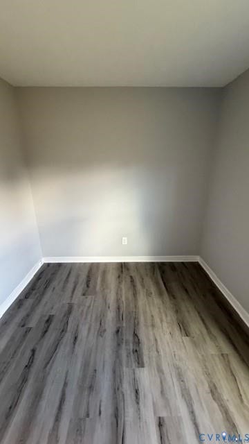 Wood-finish flooring with white trim and neutral wall paint