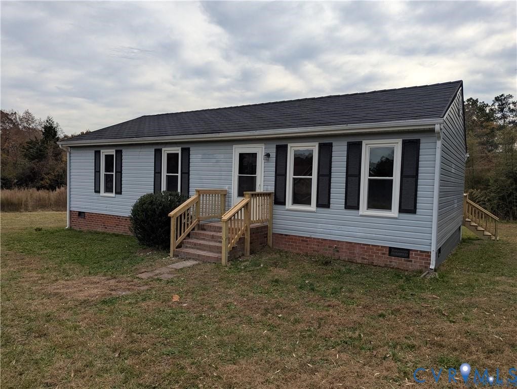 Light blue siding exterior with brick foundation