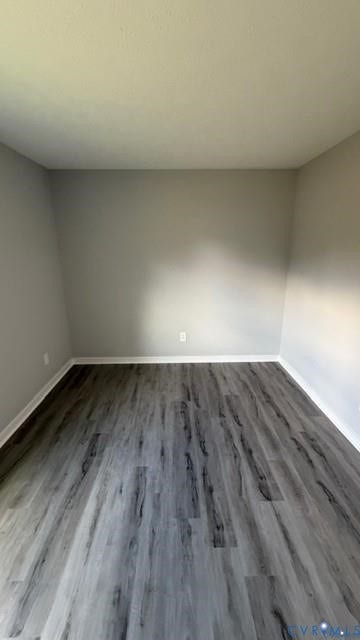 Light gray wall paint, wood-finish flooring, white baseboards, and a neutral ceiling