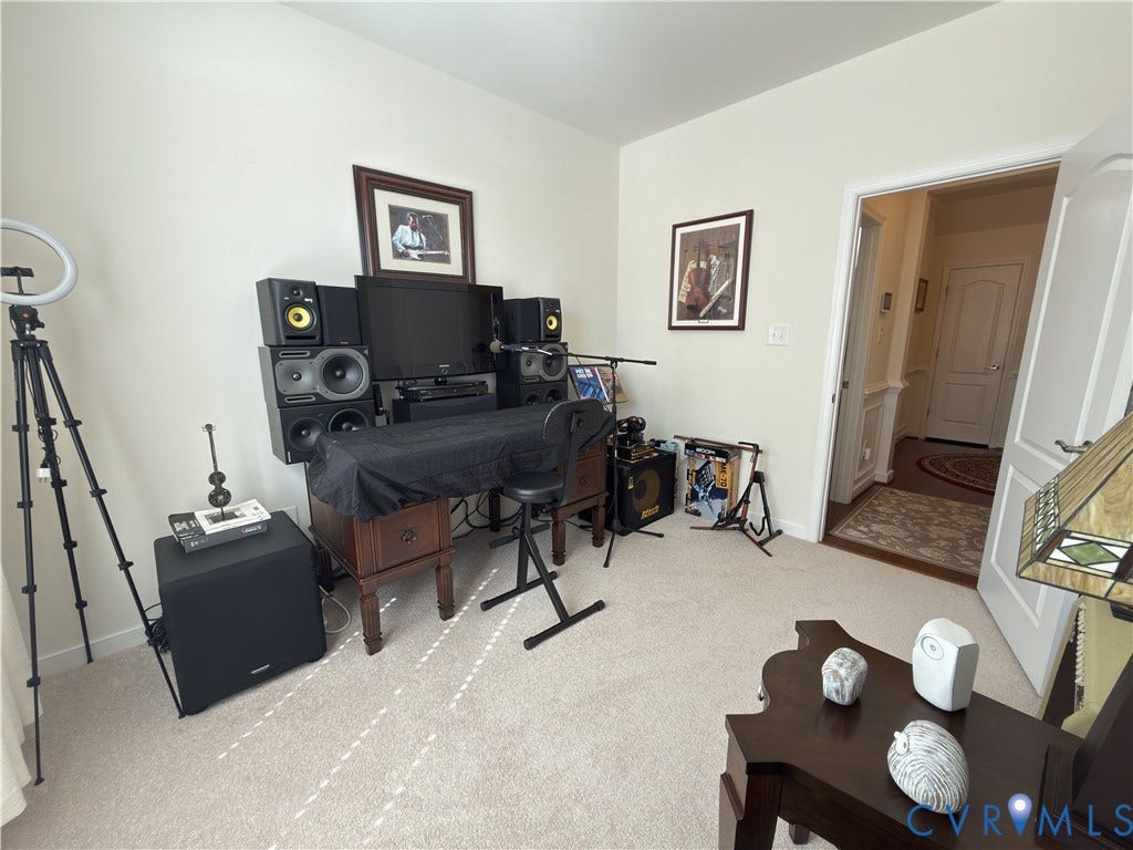 Room featuring neutral wall tones, wall-to-wall carpeting, and a multi-panel door