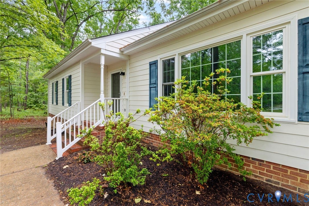 10731 Spring Run Road, Manchester, Chesterfield, VA 23832 Cream siding with brick foundation, white porch railing, and contrasting blue window shutters