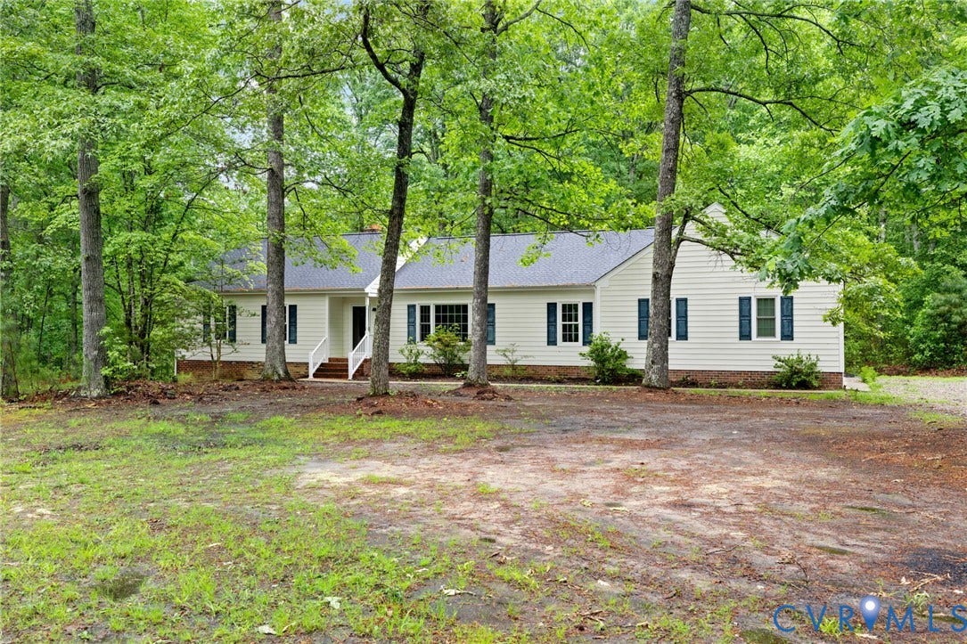 10731 Spring Run Road, Manchester, Chesterfield, VA 23832 Cottage-style residence featuring white siding, dark shutters, and a dark shingle roof