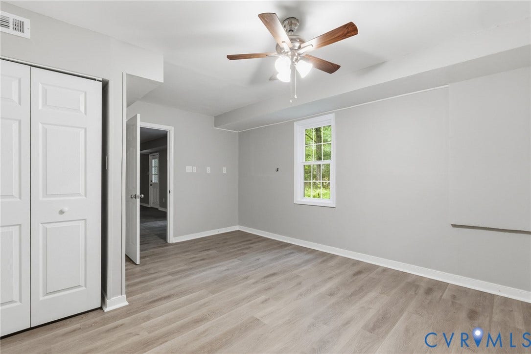 10731 Spring Run Road, Manchester, Chesterfield, VA 23832 Light grey walls with wood-finish flooring, white trim, and a ceiling fan
