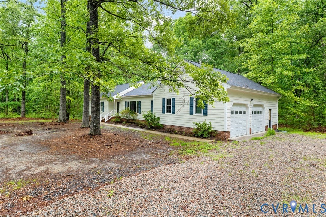 10731 Spring Run Road, Manchester, Chesterfield, VA 23832 Single-story residence featuring white siding, a dark shingle roof, and a two-car garage with white paneled doors