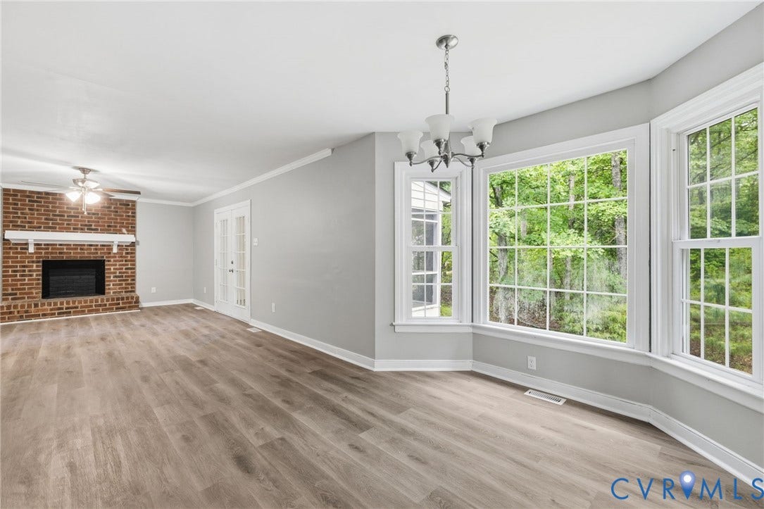 10731 Spring Run Road, Manchester, Chesterfield, VA 23832 Expansive interior featuring wood-finish flooring, a brick fireplace with mantel, French doors, a multi-pane bay window, and a ceiling fan
