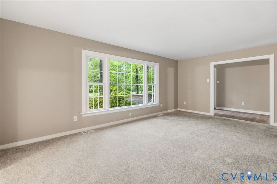 10731 Spring Run Road, Manchester, Chesterfield, VA 23832 Carpeted flooring, neutral wall tones, white trim, and a large multi-pane window