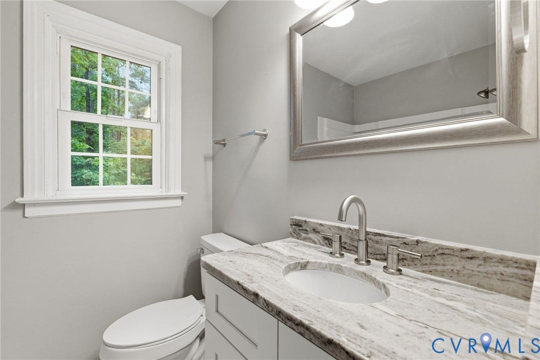 10731 Spring Run Road, Manchester, Chesterfield, VA 23832 White framed window, light gray wall color, vanity with stone countertop, undermount sink, and brushed nickel faucet