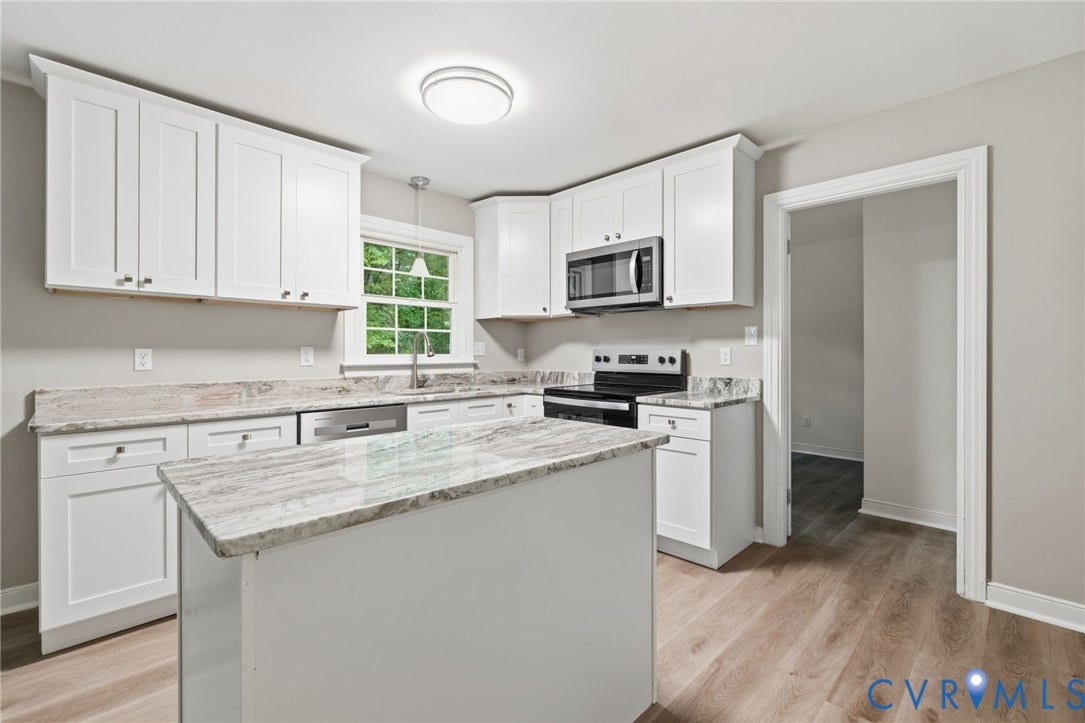 10731 Spring Run Road, Manchester, Chesterfield, VA 23832 Kitchen featuring white cabinetry, light-toned countertops, a stainless steel microwave, a built-in dishwasher, and wood-finish flooring