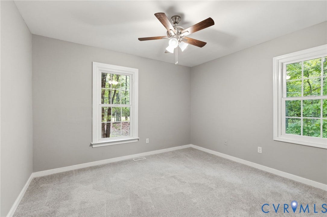 10731 Spring Run Road, Manchester, Chesterfield, VA 23832 Neutral painted walls, light-toned carpeting, two double-hung windows, and a ceiling fan with light fixture
