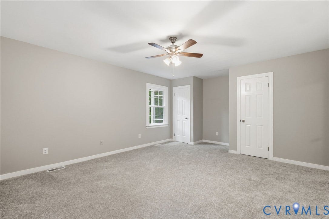 10731 Spring Run Road, Manchester, Chesterfield, VA 23832 Neutral wall color, light gray carpeting, ceiling fan with integrated lighting, white trim and doors, double-paned window