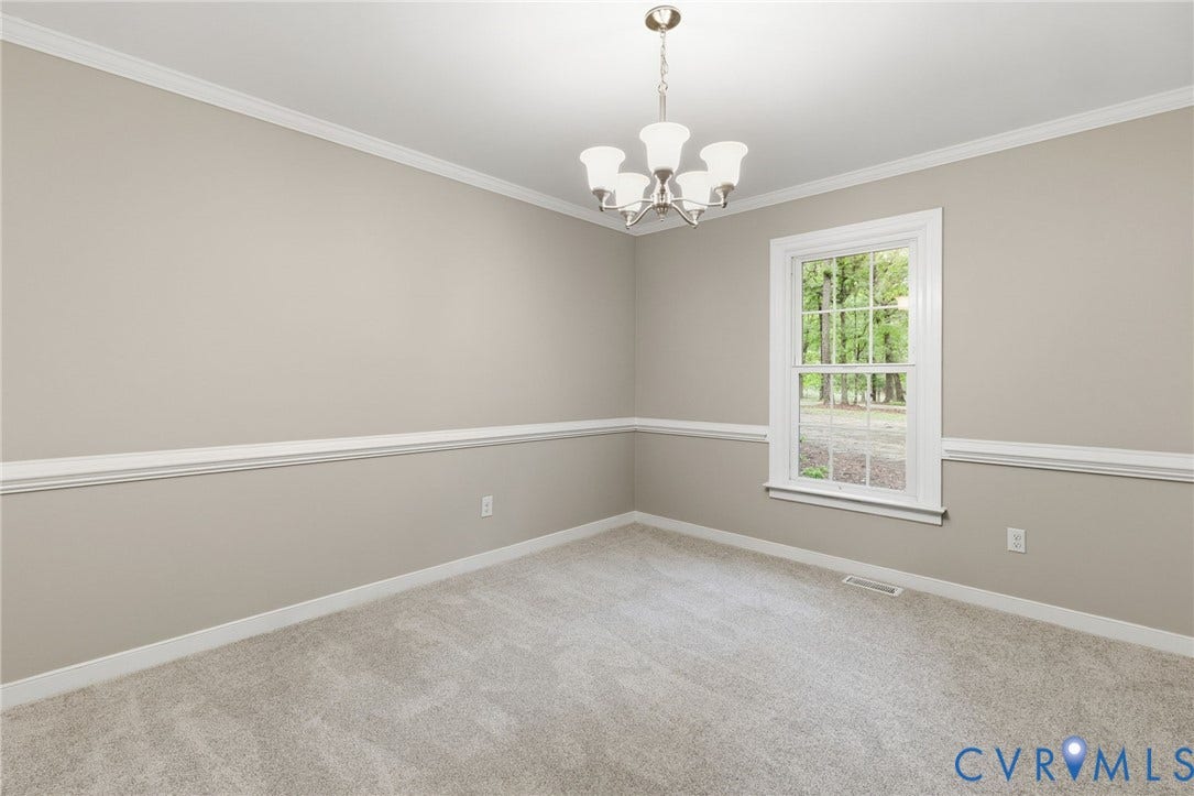 10731 Spring Run Road, Manchester, Chesterfield, VA 23832 Neutral wall paint with chair rail molding and crown molding, light-colored carpet flooring, and a single window