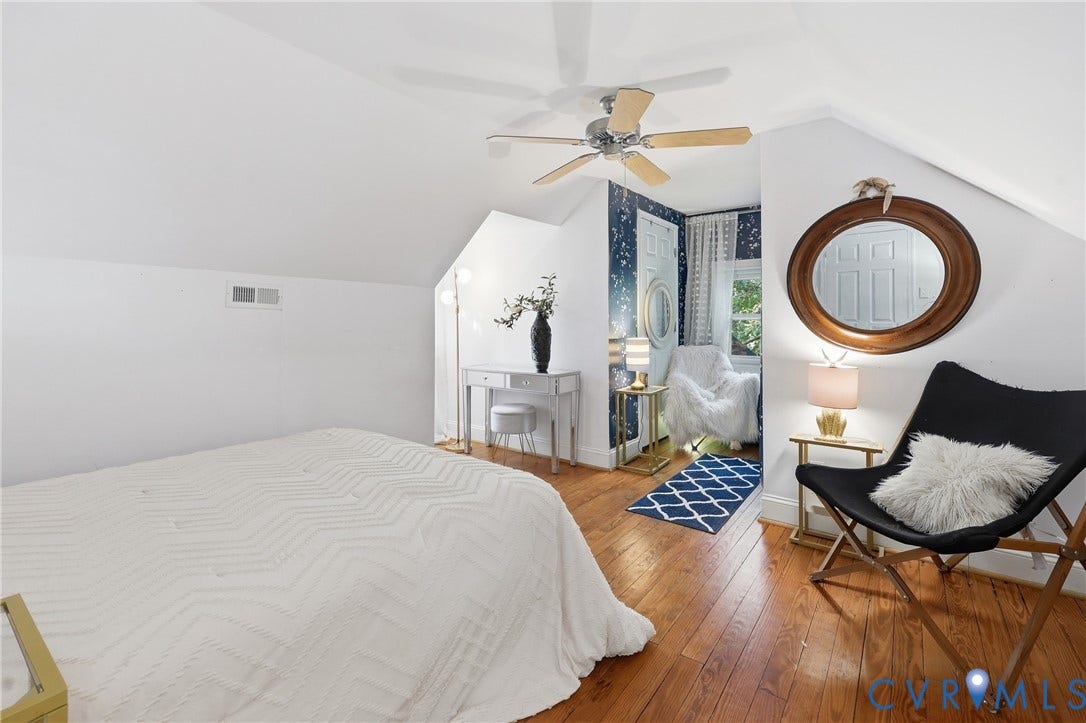 Hardwood-finish flooring, sloped ceiling, ceiling fan, white walls
