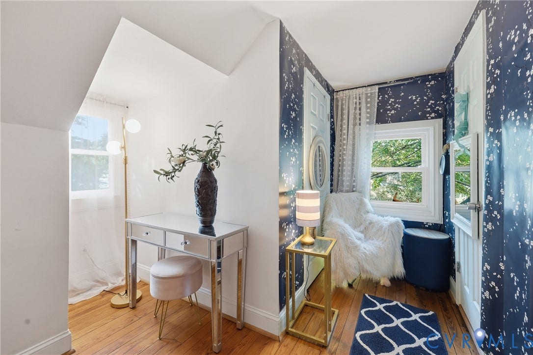 Attic space with wood-finish flooring and a mirrored vanity