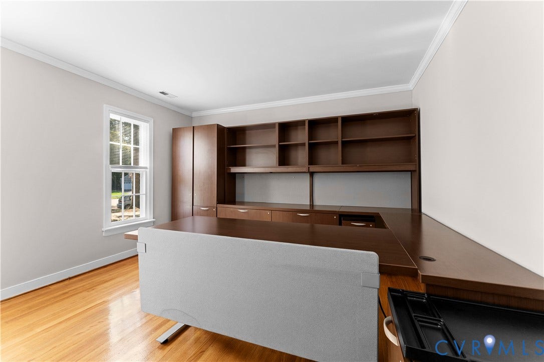 2307 Garrison Place Terrace, Garrison Place, Midlothian, VA 23112 Built-in wood-finish cabinetry featuring open shelving and integrated desk surfaces, paired with wood-finish flooring and a single-hung window with white casing