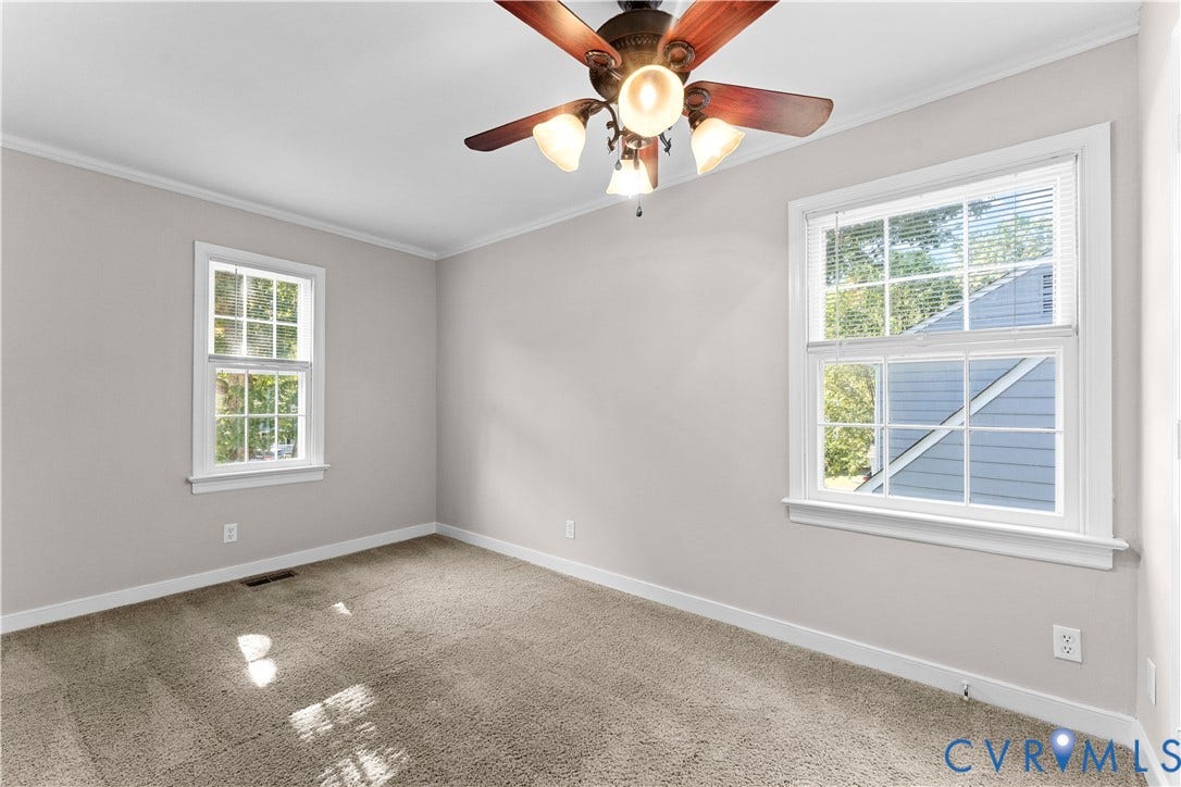 2307 Garrison Place Terrace, Garrison Place, Midlothian, VA 23112 Neutral interior featuring neutral-toned carpeting, two windows with white casings, and a ceiling fan with four integrated light fixtures