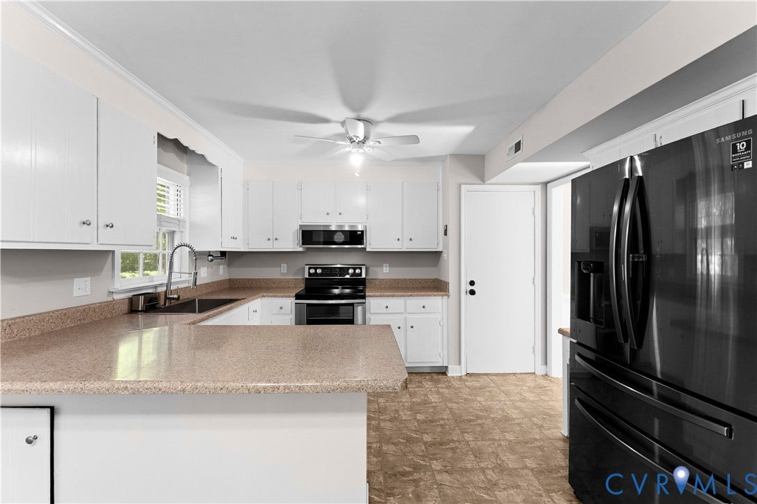 2307 Garrison Place Terrace, Garrison Place, Midlothian, VA 23112 Kitchen featuring white cabinetry, solid-surface countertops, black finish appliances, built-in microwave, and a ceiling fan