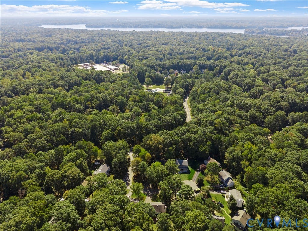 2307 Garrison Place Terrace, Garrison Place, Midlothian, VA 23112 Aerial perspective featuring mature tree canopy, dense woodland surroundings, paved road access, and distant water backdrop