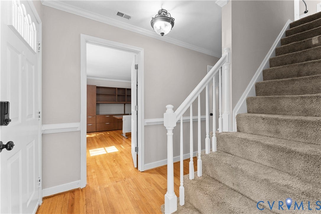 2307 Garrison Place Terrace, Garrison Place, Midlothian, VA 23112 Foyer featuring wood-finish flooring, a white staircase with a wooden handrail, crown molding, chair rail trim, and a ceiling-mounted light fixture