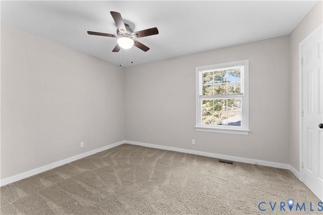 2307 Garrison Place Terrace, Garrison Place, Midlothian, VA 23112 Neutral-toned interior featuring wall-to-wall carpeting, a multi-blade ceiling fan with integrated lighting, a single-hung window with muntins, and a six-panel door