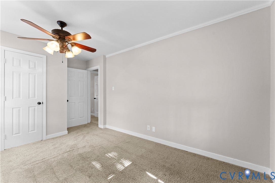 2307 Garrison Place Terrace, Garrison Place, Midlothian, VA 23112 Neutral-toned interior featuring wall-to-wall carpeting, crown molding, multi-panel doors, and a ceiling fan with integrated lighting