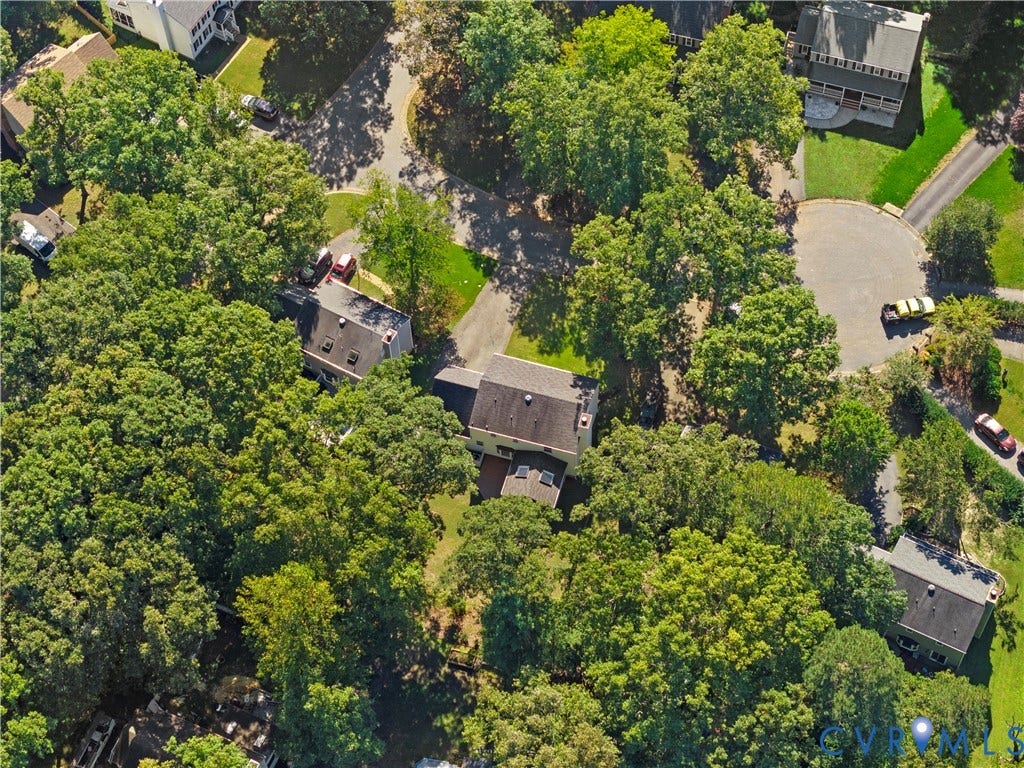 2307 Garrison Place Terrace, Garrison Place, Midlothian, VA 23112 Aerial perspective of a multi-level residence featuring a dark shingle roof, chimney, multiple skylights, and extensive surrounding tree canopy