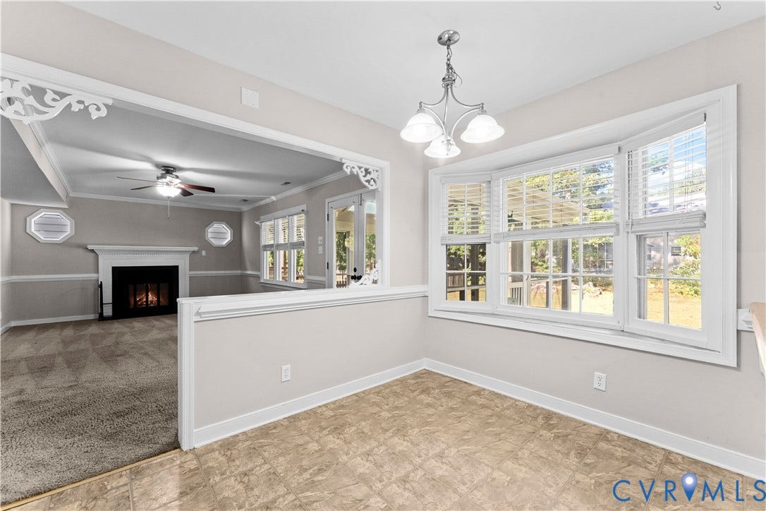 2307 Garrison Place Terrace, Garrison Place, Midlothian, VA 23112 Dining area featuring a bay window, decorative crown molding trim, tile flooring, and a multi-arm chandelier