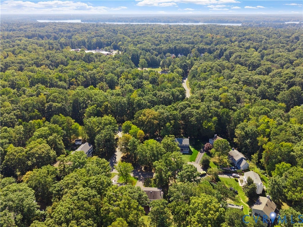 2307 Garrison Place Terrace, Garrison Place, Midlothian, VA 23112 Aerial perspective featuring dense mature tree coverage, asphalt roadways, and a distant water backdrop
