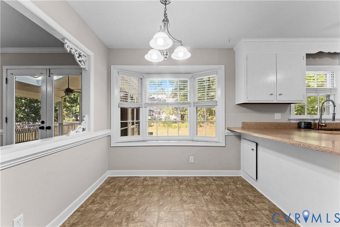 2307 Garrison Place Terrace, Garrison Place, Midlothian, VA 23112 Bay window with natural light, multi-arm overhead lighting, white cabinetry, solid-surface countertop, and interior window pass-through with decorative trim