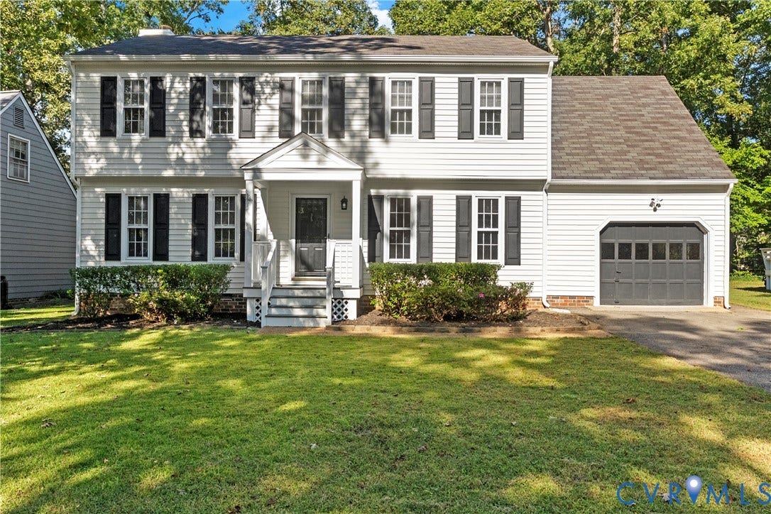 2307 Garrison Place Terrace, Garrison Place, Midlothian, VA 23112 Colonial-style exterior featuring white horizontal siding, dark window shutters, an attached garage, a covered front entryway, and a landscaped lawn