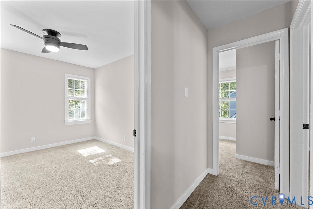 2307 Garrison Place Terrace, Garrison Place, Midlothian, VA 23112 Neutral-toned interior featuring wall-to-wall carpeting, multi-pane windows, and a ceiling-mounted light fixture with a fan