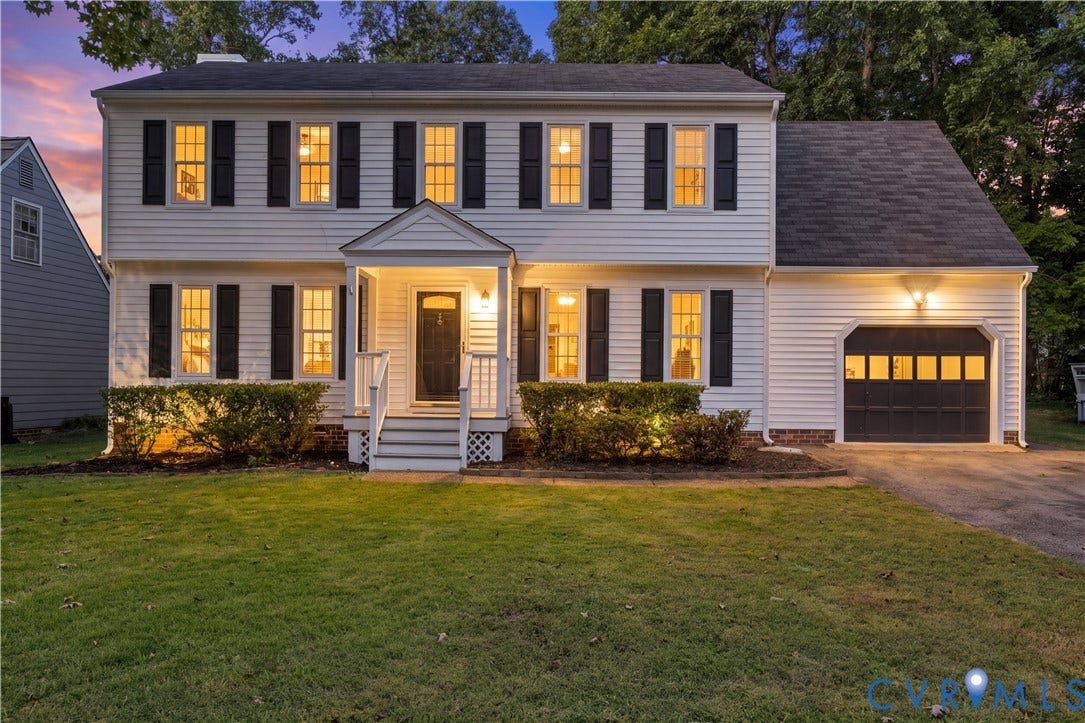 2307 Garrison Place Terrace, Garrison Place, Midlothian, VA 23112 Two-story residence featuring horizontal lap siding, a covered entryway with a gabled porch, shutter-framed windows, and an attached garage with a multi-pane door
