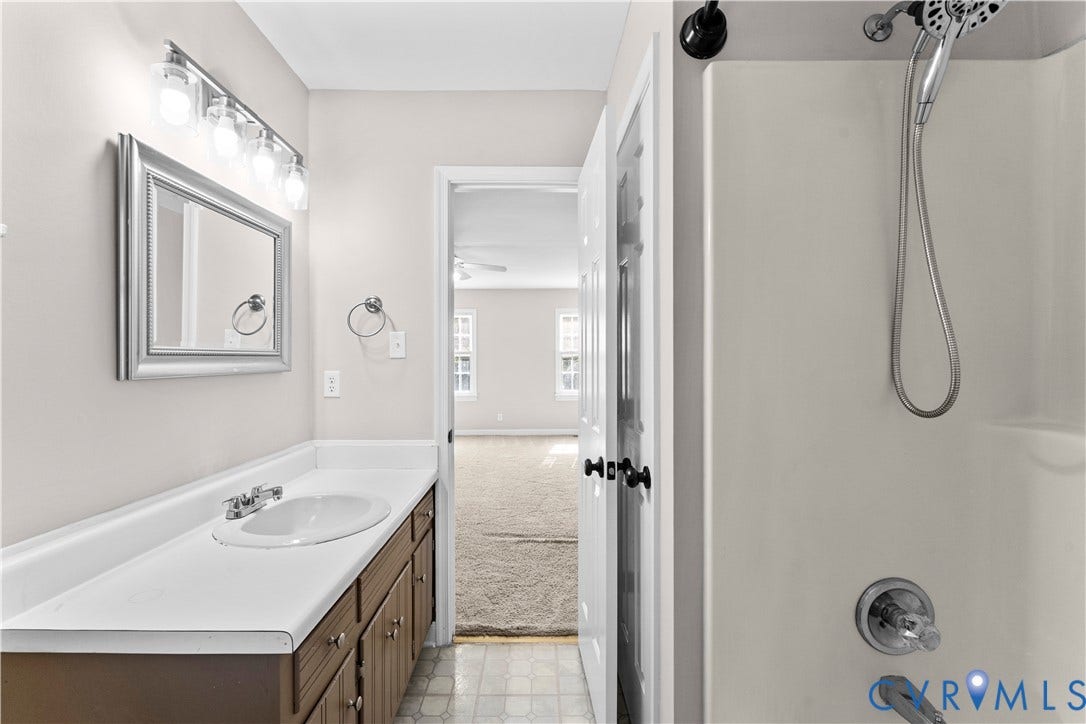 2307 Garrison Place Terrace, Garrison Place, Midlothian, VA 23112 Bathroom featuring a vanity with an integrated sink and countertop, wall-mounted four-light fixture, framed mirror, and a tub-shower combination with a handheld showerhead