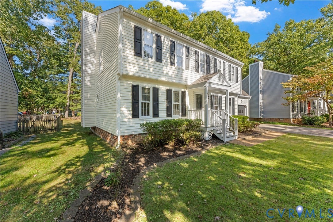 2307 Garrison Place Terrace, Garrison Place, Midlothian, VA 23112 Two-story vinyl-sided exterior featuring dark shutters, a covered front entry porch, brick foundation accent, and a stone-lined garden bed