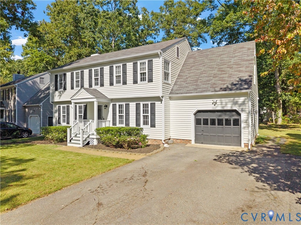 2307 Garrison Place Terrace, Garrison Place, Midlothian, VA 23112 Two-story colonial exterior featuring light-colored horizontal siding, dark decorative shutters, a covered front entryway, and an attached garage