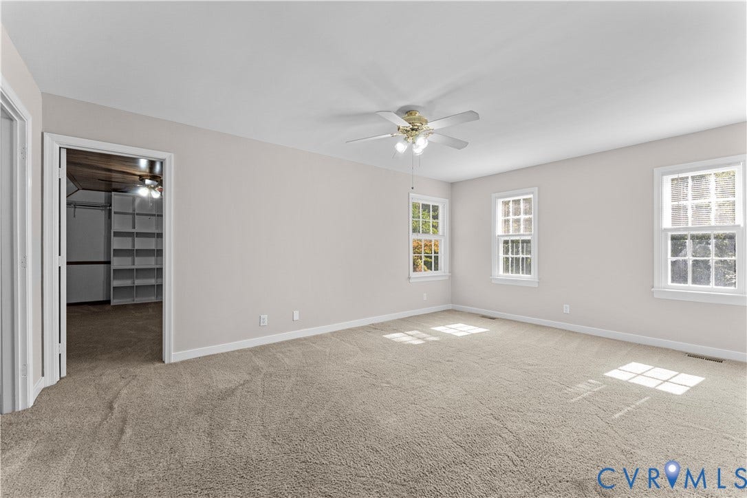 2307 Garrison Place Terrace, Garrison Place, Midlothian, VA 23112 Neutral wall tones, wall-to-wall carpeting, three multi-pane windows, a central ceiling fan with integrated lighting, and built-in closet shelving