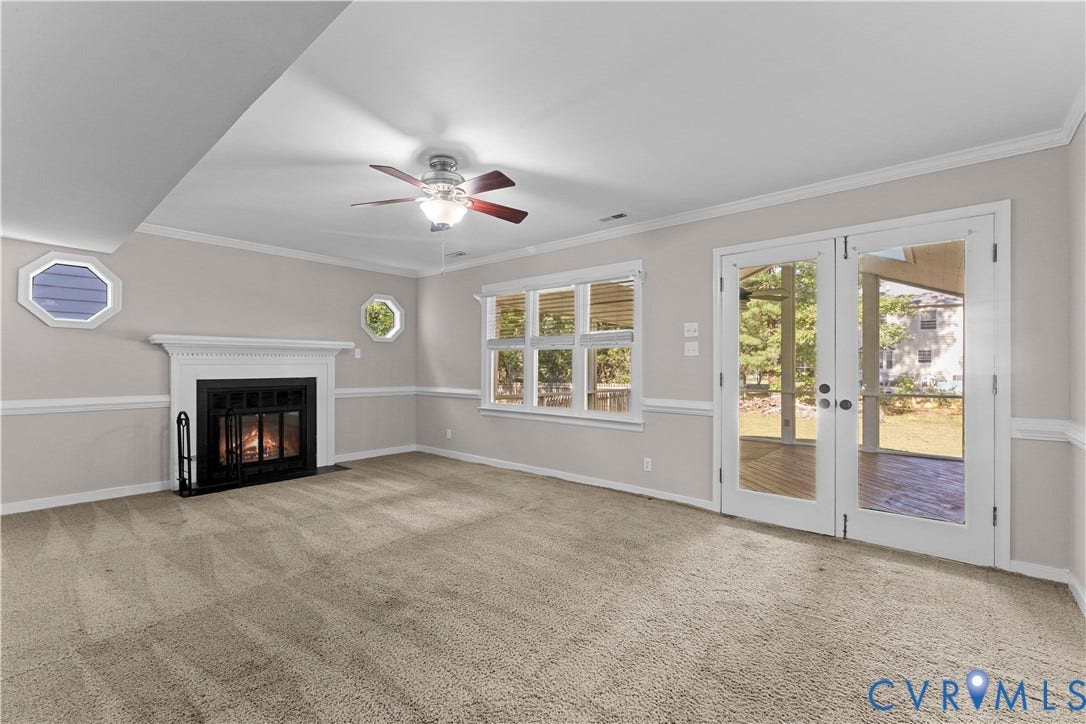 2307 Garrison Place Terrace, Garrison Place, Midlothian, VA 23112 Fireplace with white mantle, multi-pane window configuration, octagonal windows, double glass-panel doors, and ceiling fan with integrated light fixture