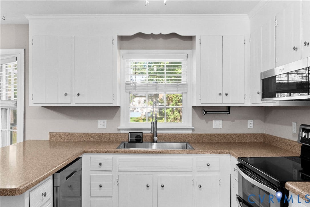 2307 Garrison Place Terrace, Garrison Place, Midlothian, VA 23112 Kitchen featuring white cabinetry with crown molding, stone-flecked countertops, stainless steel undermount sink with arched faucet, and integrated stainless steel appliances