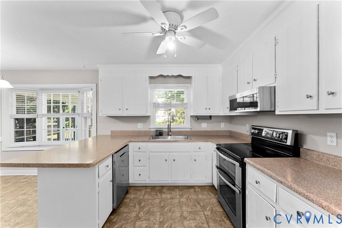 2307 Garrison Place Terrace, Garrison Place, Midlothian, VA 23112 Kitchen featuring white cabinetry, solid-surface countertops, a stainless steel sink, a bay window, and a ceiling fan